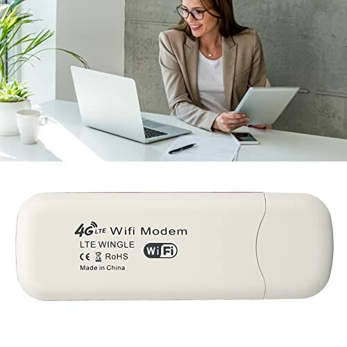 Woman using laptop with 4G LTE WiFi modem