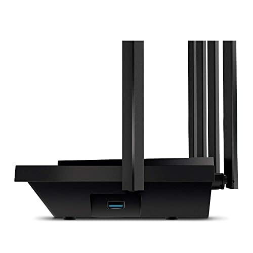 Side view of a black wireless router with antennas.