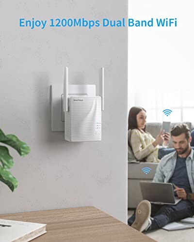 WiFi range extender plugged into a wall outlet with people using devices in the background.